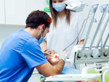 Medical scene of cute young woman at the dentist.